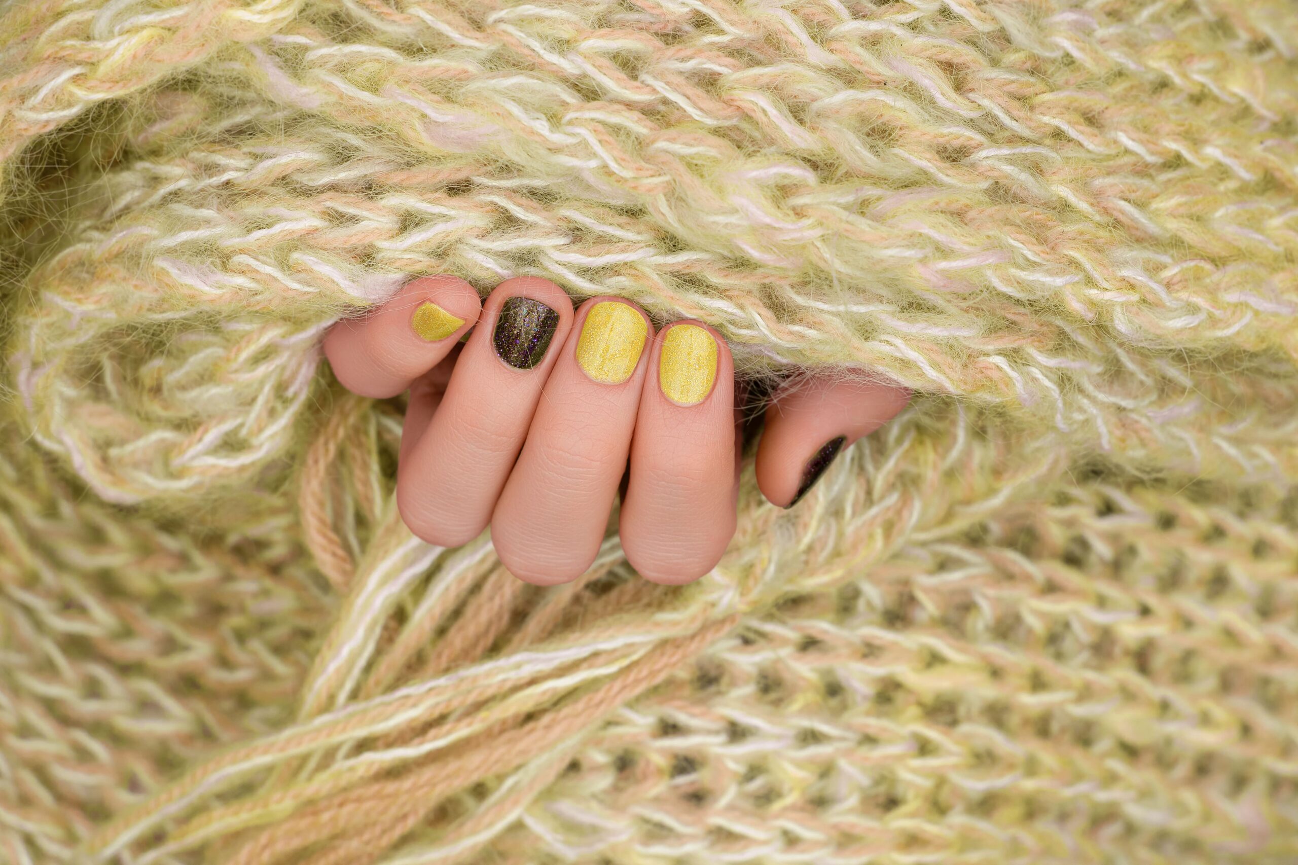 yellow-nail-design-manicured-female-hand-with-glitter-manicure